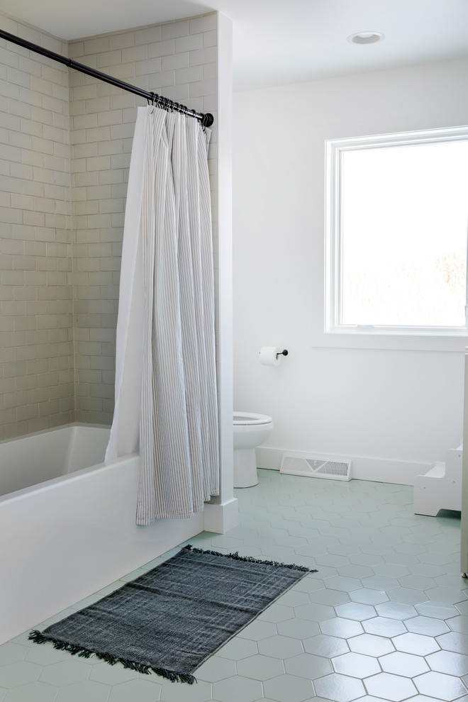 This is an example of a large scandinavian kids bathroom in Grand Rapids with flat-panel cabinets, white cabinets, an alcove tub, an open shower, beige tile, ceramic tile, white walls, ceramic floors, an undermount sink, quartzite benchtops, green floor, a shower curtain and white benchtops.