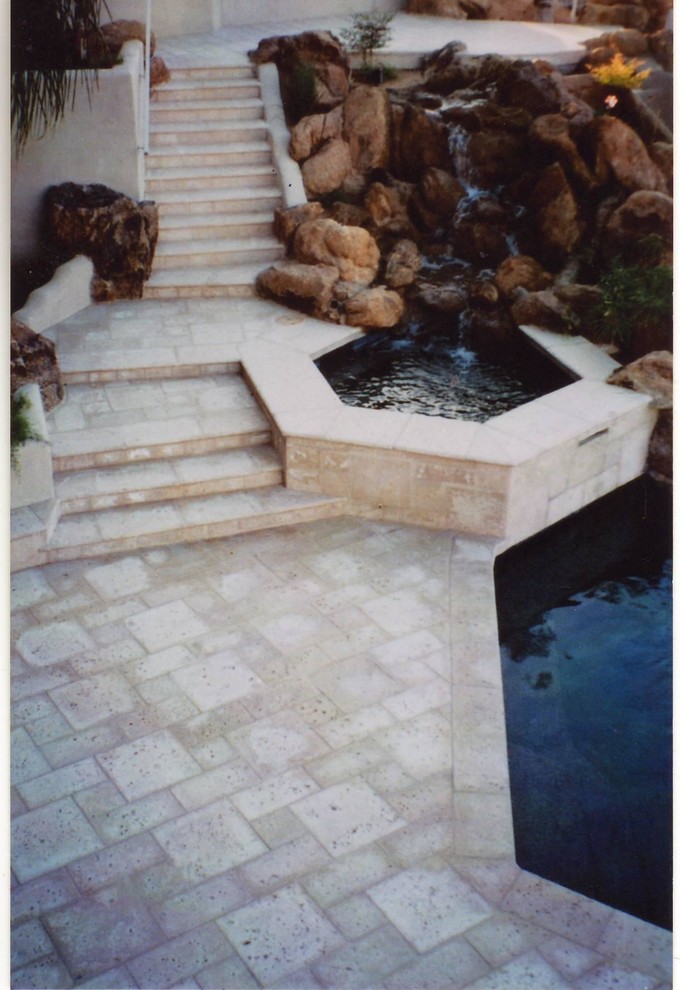 This is an example of a large mediterranean backyard patio in Phoenix with concrete pavers.