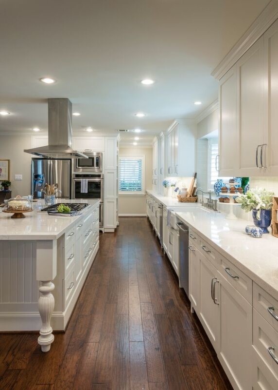 Large country l-shaped open plan kitchen in Houston with a farmhouse sink, shaker cabinets, white cabinets, quartz benchtops, blue splashback, ceramic splashback, stainless steel appliances, medium hardwood floors and with island.