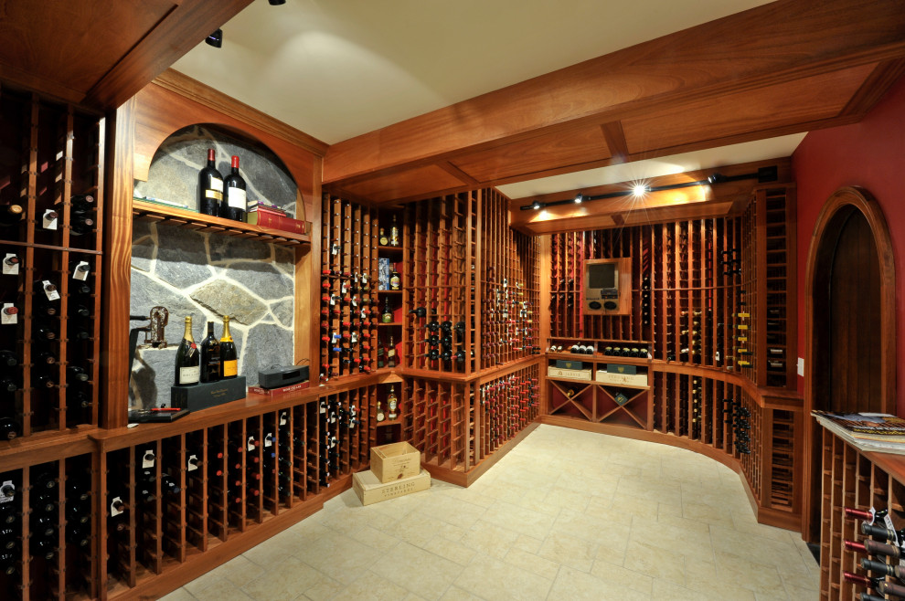 Inspiration for an expansive traditional wine cellar in Other with ceramic floors, display racks and beige floor.