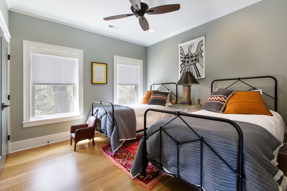 Photo of an eclectic kids' room in Other with grey walls, light hardwood floors and beige floor.