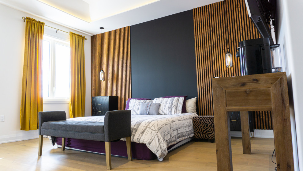 Mid-sized midcentury master bedroom in Toronto with white walls, light hardwood floors, beige floor and wood walls.