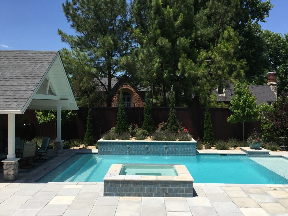 Example of a large transitional backyard concrete paver and rectangular hot tub design