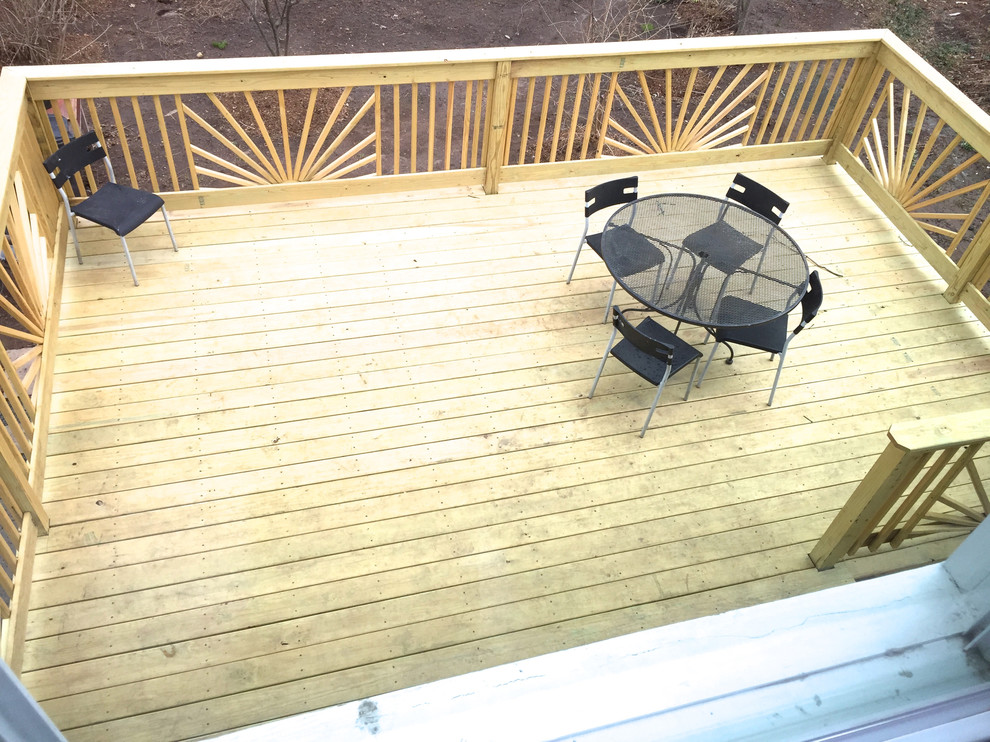 Large eclectic backyard deck in New York with no cover.
