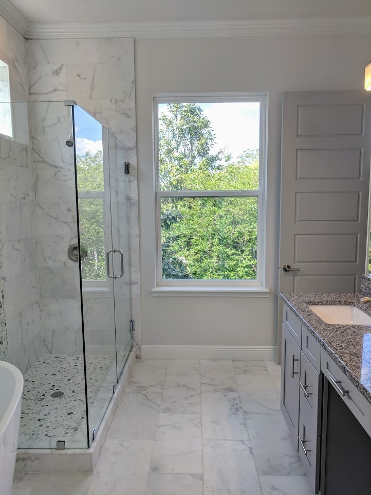 Inspiration for a mid-sized contemporary master bathroom in Miami with recessed-panel cabinets, grey cabinets, a freestanding tub, a corner shower, a one-piece toilet, white tile, marble, white walls, marble floors, an undermount sink, granite benchtops, white floor, a shower curtain and grey benchtops.