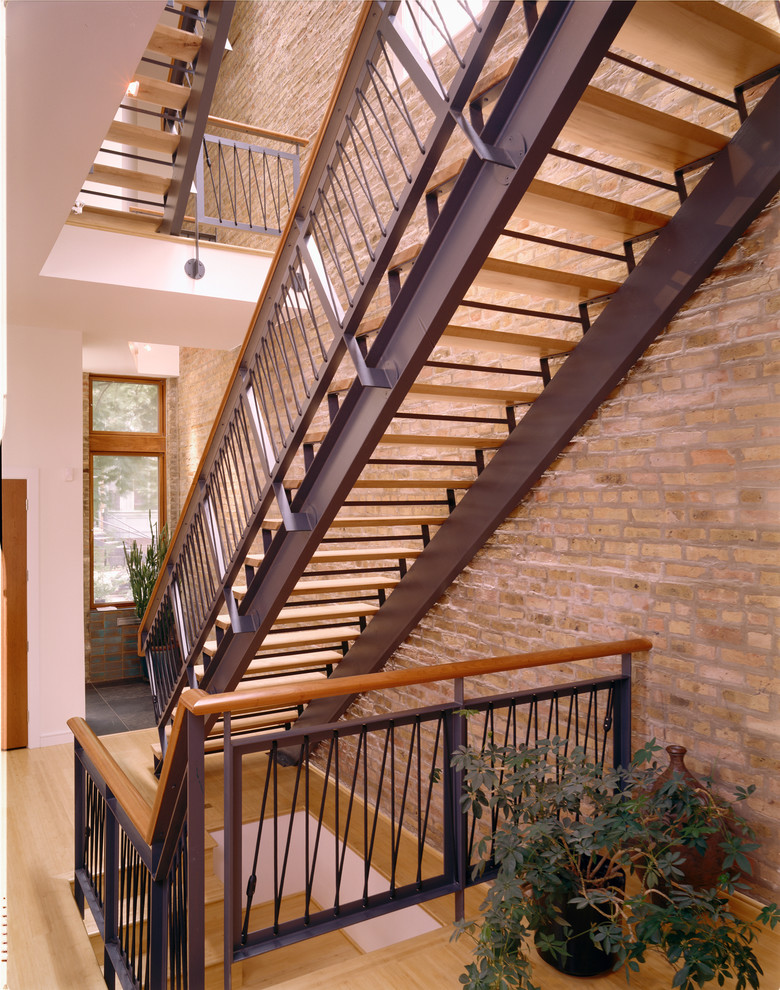 Design ideas for a large contemporary wood straight staircase in Chicago with open risers and wood railing.
