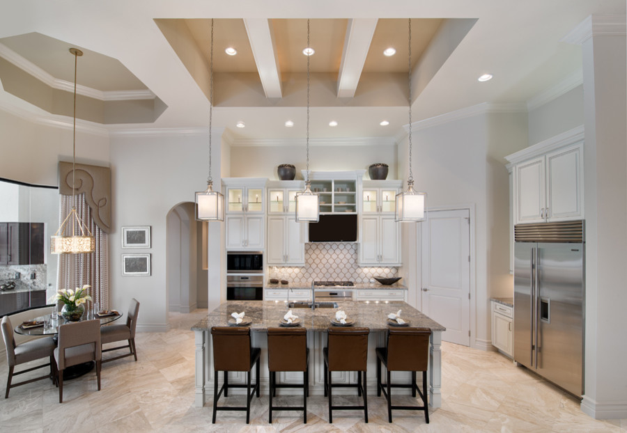 Example of a large transitional l-shaped ceramic tile eat-in kitchen design with a drop-in sink, glass-front cabinets, white cabinets, granite countertops, beige backsplash, ceramic backsplash, stainless steel appliances and an island