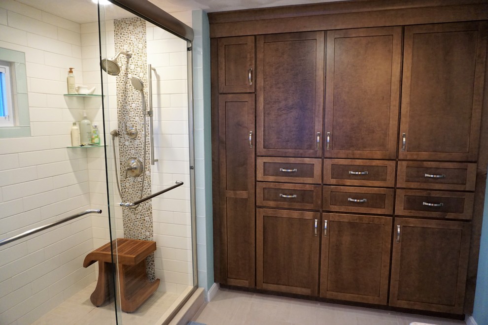 Home design - mid-sized transitional master white tile and subway tile porcelain tile and beige floor home design idea in Providence with recessed-panel cabinets, brown cabinets, blue walls, an undermount sink, quartz countertops and multicolored countertops