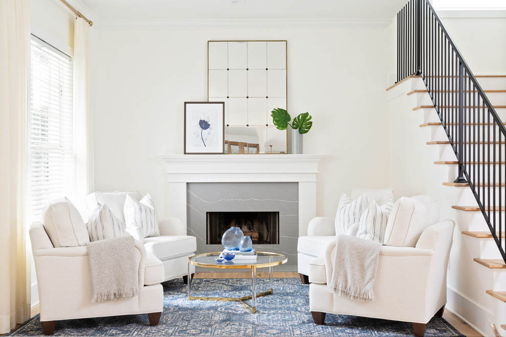 Inspiration for a mid-sized transitional formal open concept living room in Orlando with white walls, light hardwood floors, a standard fireplace, a tile fireplace surround, no tv and brown floor.