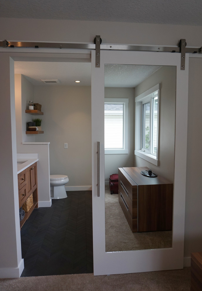 This is an example of a mid-sized transitional master bedroom in Calgary with beige walls.