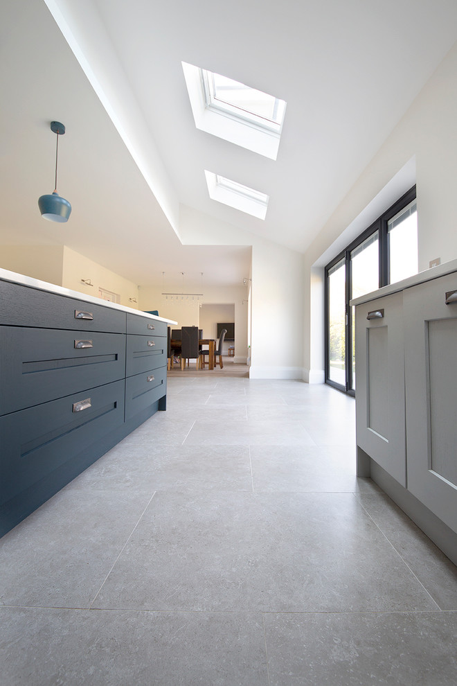 This is an example of a large contemporary l-shaped eat-in kitchen in Other with porcelain floors, with island and grey floor.