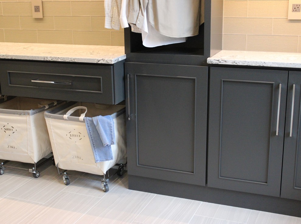 Design ideas for a large transitional l-shaped dedicated laundry room in Chicago with an undermount sink, flat-panel cabinets, grey cabinets, quartz benchtops, grey walls, ceramic floors and a side-by-side washer and dryer.