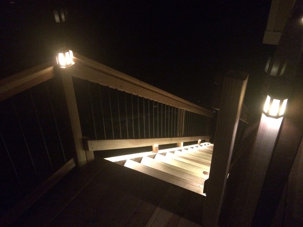 Example of a mid-sized mountain style backyard deck design in Denver with a pergola