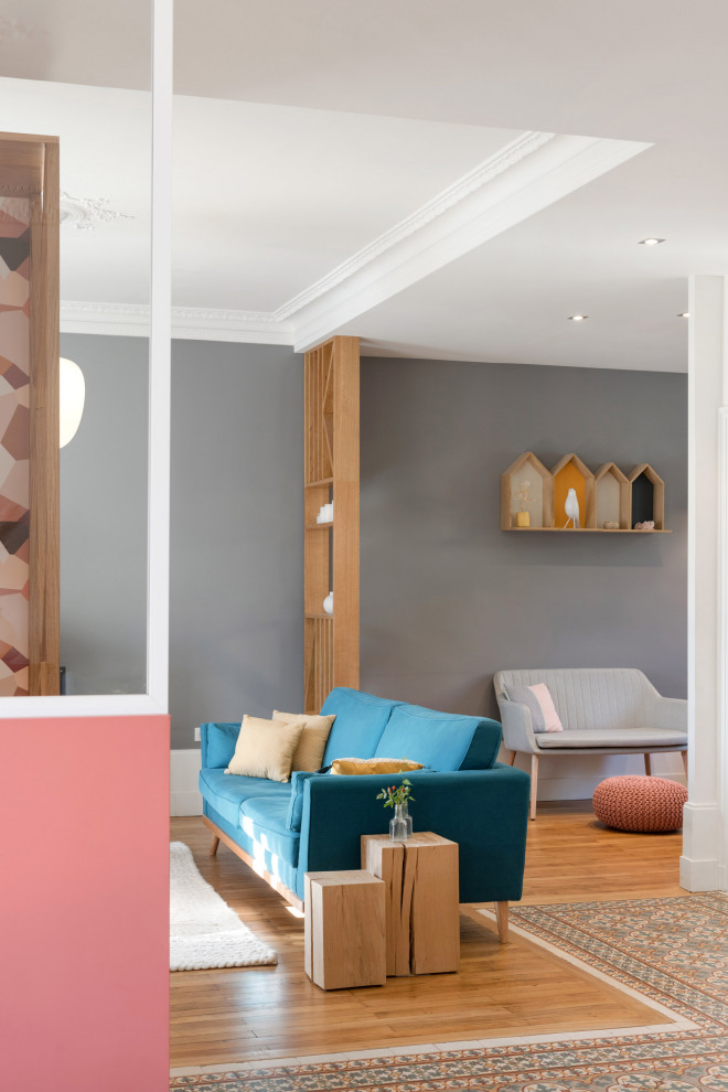 Inspiration pour une grande salle de séjour design ouverte avec une bibliothèque ou un coin lecture, un mur rose, sol en béton ciré, une cheminée double-face, un manteau de cheminée en pierre et un sol multicolore.