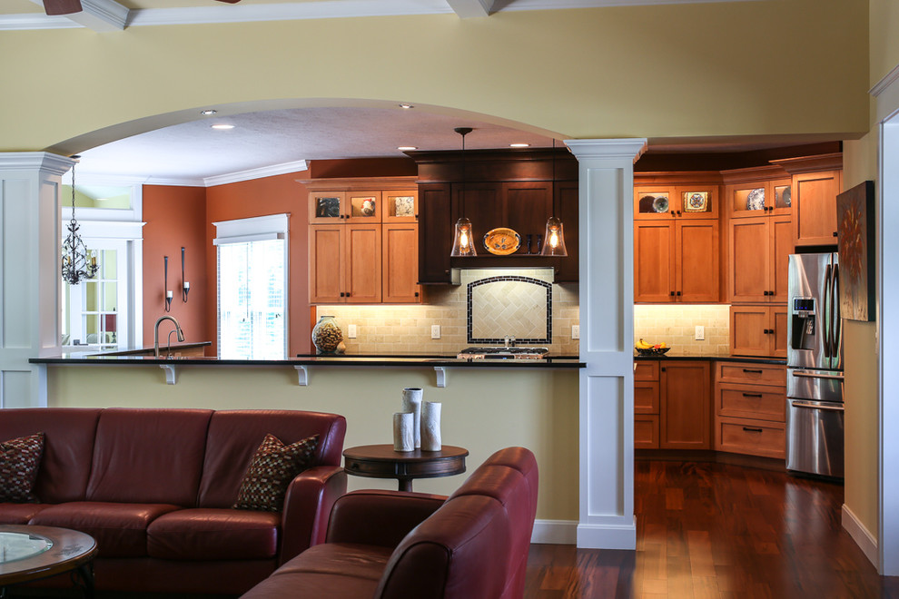 Kitchen - huge transitional medium tone wood floor kitchen idea with an undermount sink, shaker cabinets, light wood cabinets, granite countertops, beige backsplash, porcelain backsplash, stainless steel appliances and an island