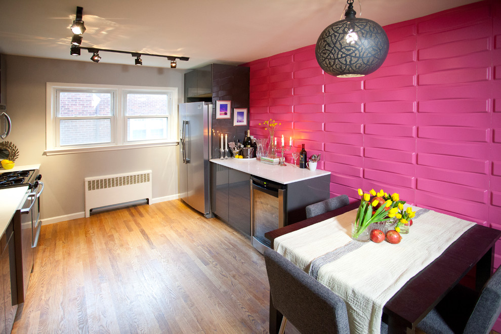Photo of a contemporary eat-in kitchen in New York with flat-panel cabinets, grey cabinets, pink splashback and stainless steel appliances.