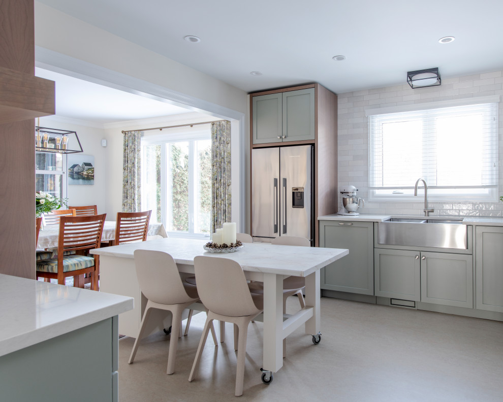 Example of a mid-sized transitional u-shaped linoleum floor and gray floor eat-in kitchen design in Ottawa with a farmhouse sink, shaker cabinets, gray cabinets, quartz countertops, white backsplash, subway tile backsplash, stainless steel appliances, an island and white countertops