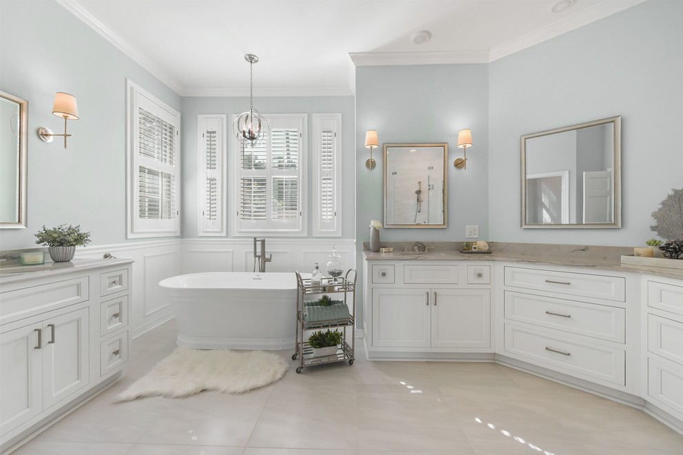 Photo of a large transitional master bathroom in Jacksonville with beaded inset cabinets, white cabinets and a freestanding tub.