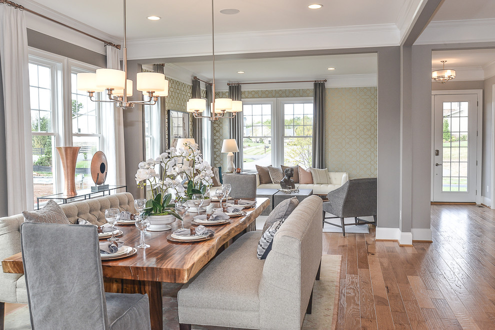 Design ideas for a mid-sized transitional open plan dining in DC Metro with multi-coloured walls, medium hardwood floors and a standard fireplace.