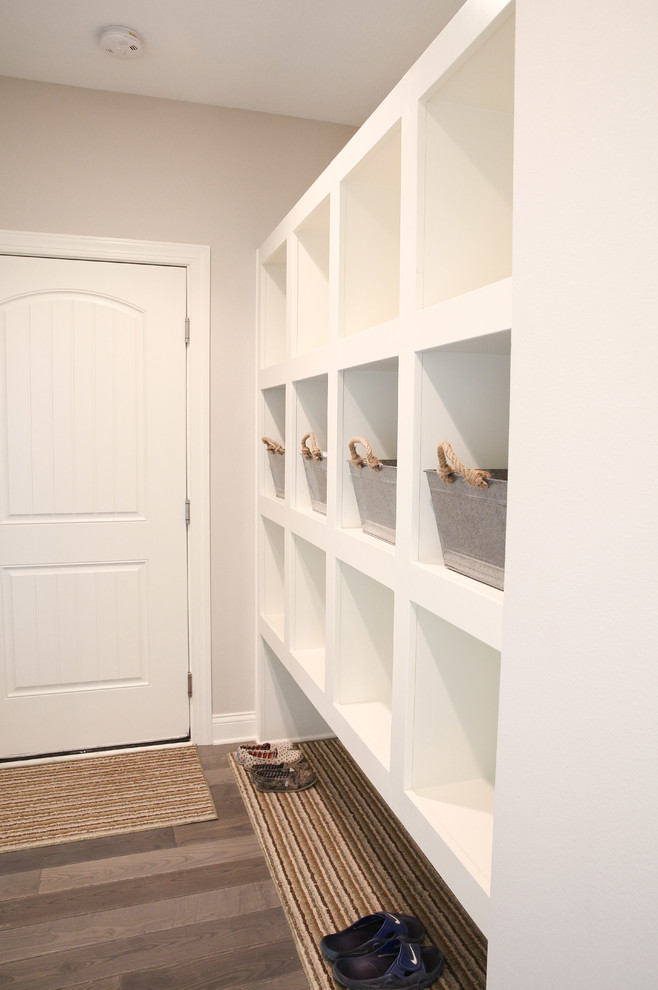 Inspiration for a transitional mudroom remodel with gray walls and a white front door