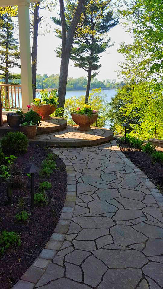 Inspiration for a mid-sized transitional front yard full sun formal garden for summer in New York with a garden path and natural stone pavers.