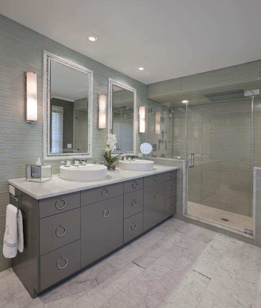Inspiration for a mid-sized contemporary master bathroom in New York with a vessel sink, grey cabinets, flat-panel cabinets, an alcove shower, a two-piece toilet, grey walls, marble floors, marble benchtops, white floor and a hinged shower door.