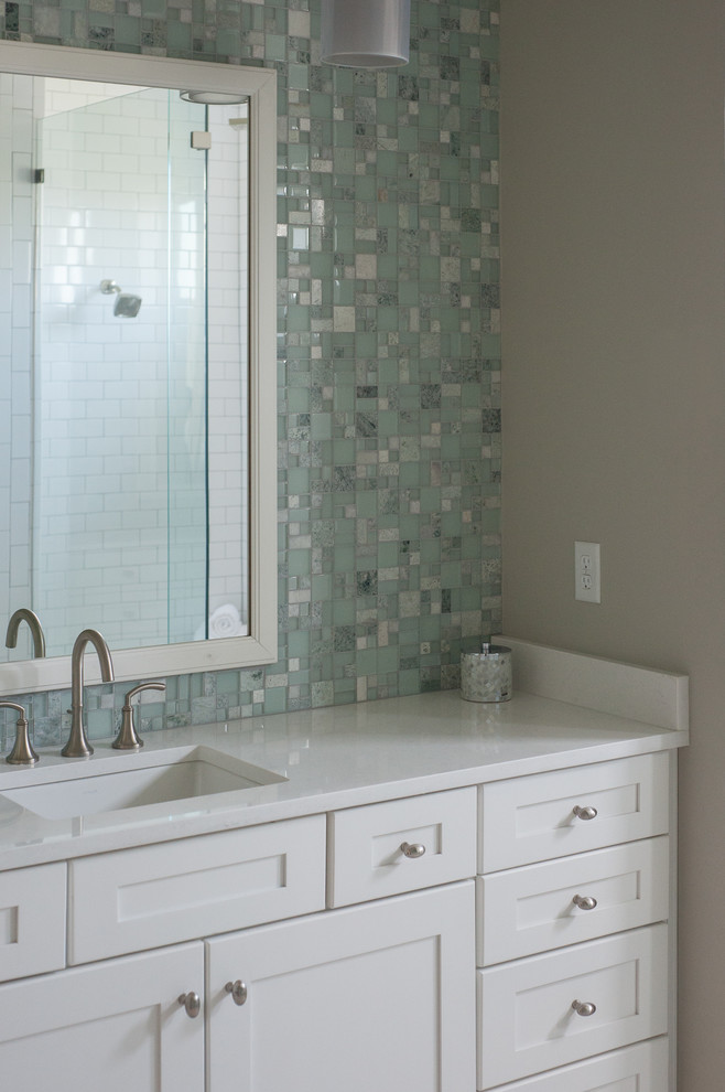 This is an example of a mid-sized country master bathroom in Jacksonville with beaded inset cabinets, white cabinets, an open shower, a one-piece toilet, blue tile, ceramic tile, grey walls, a drop-in sink and solid surface benchtops.