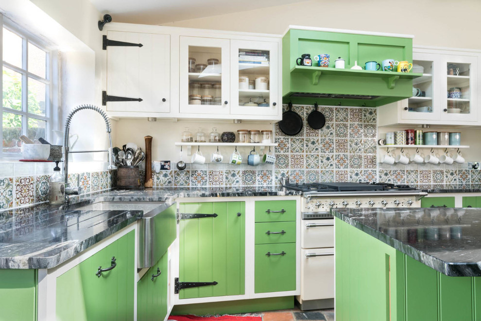 Inspiration for a small country l-shaped eat-in kitchen in Essex with a farmhouse sink, green cabinets, granite benchtops, multi-coloured splashback, with island, multi-coloured floor, black benchtop, flat-panel cabinets and white appliances.