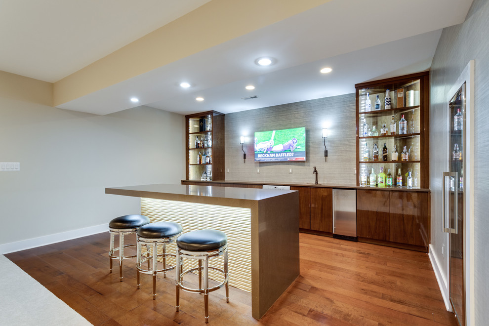 Design ideas for a transitional single-wall wet bar in DC Metro with an undermount sink, flat-panel cabinets, dark wood cabinets, quartz benchtops, brown splashback, dark hardwood floors, brown floor and brown benchtop.