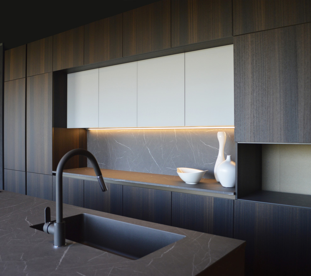 Esempio di una cucina minimalista di medie dimensioni con lavello sottopiano, ante lisce, ante in legno bruno, top in laminato, paraspruzzi grigio, parquet scuro, pavimento marrone e top grigio