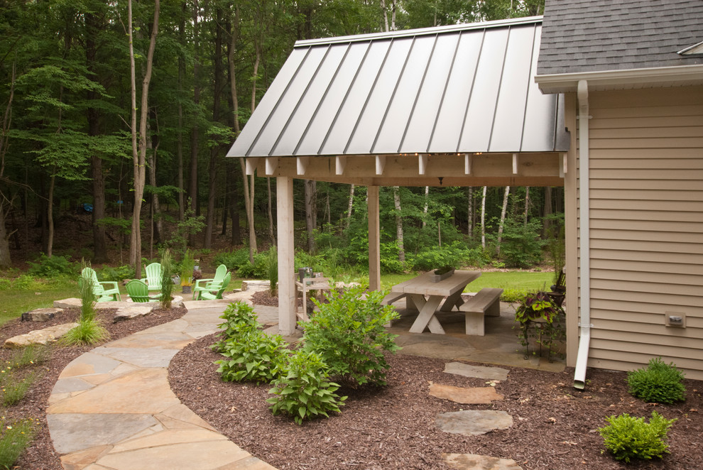 Patio - mid-sized transitional backyard concrete patio idea with a fire pit and a roof extension