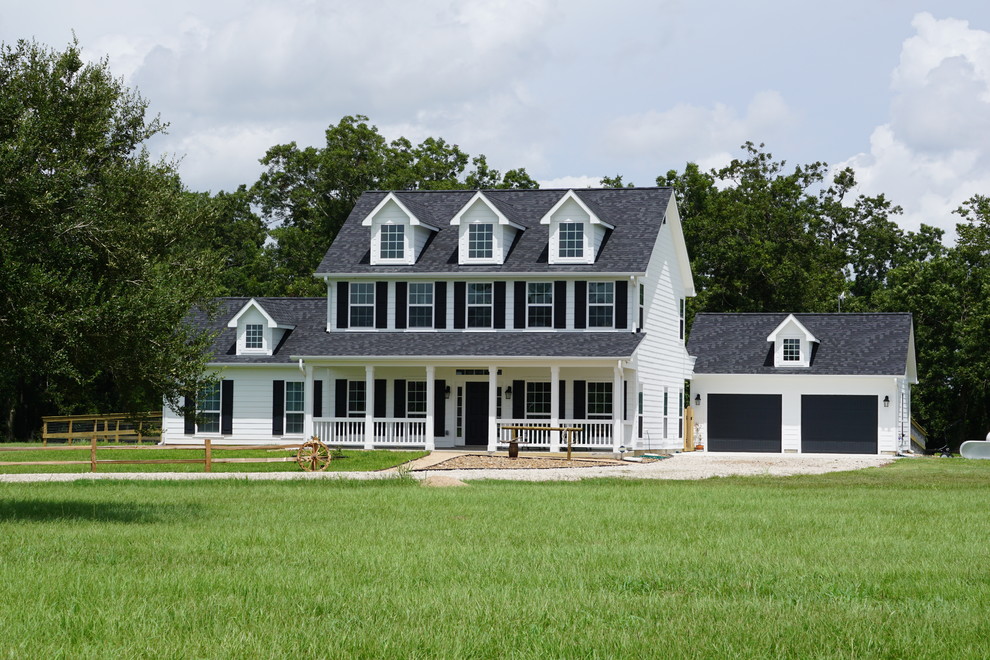Inspiration for a large country white two-story wood house exterior remodel in Atlanta with a hip roof and a shingle roof