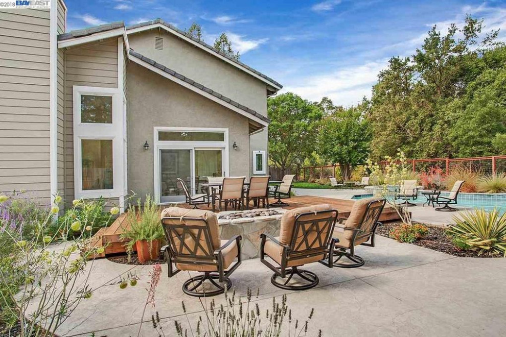 Patio - large backyard drought-tolerant and full sun patio idea in San Francisco with a fire pit
