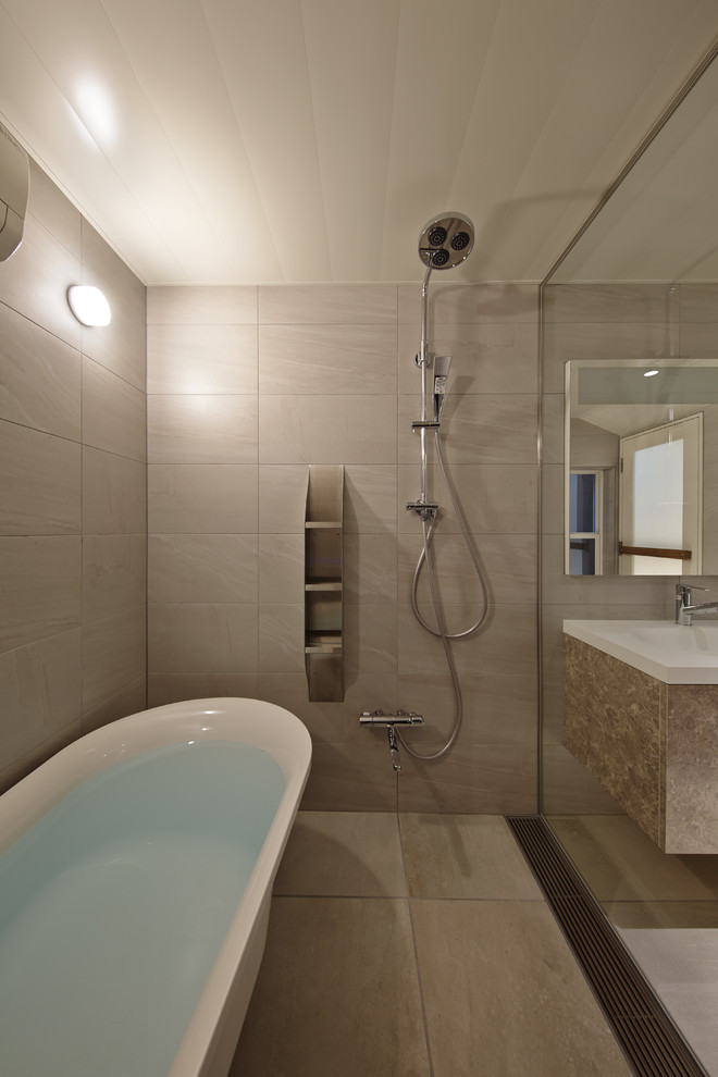 This is an example of a large asian master bathroom in Kyoto with flat-panel cabinets, orange cabinets, a claw-foot tub, a double shower, a one-piece toilet, gray tile, ceramic tile, grey walls, porcelain floors, a wall-mount sink, solid surface benchtops, white floor and a hinged shower door.