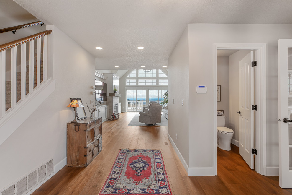 This is an example of a large country foyer in Portland with grey walls, medium hardwood flooring, brown floors and a vaulted ceiling.