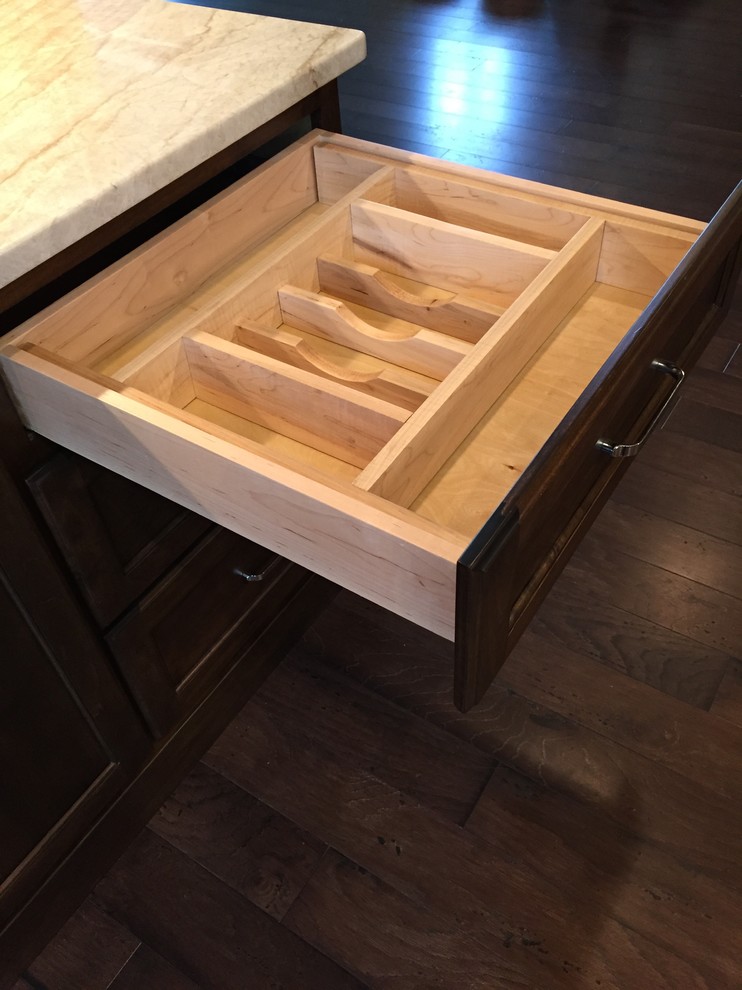 Kitchen - mid-sized transitional dark wood floor kitchen idea in Austin with a farmhouse sink, flat-panel cabinets, dark wood cabinets, quartzite countertops, beige backsplash, stone tile backsplash and stainless steel appliances