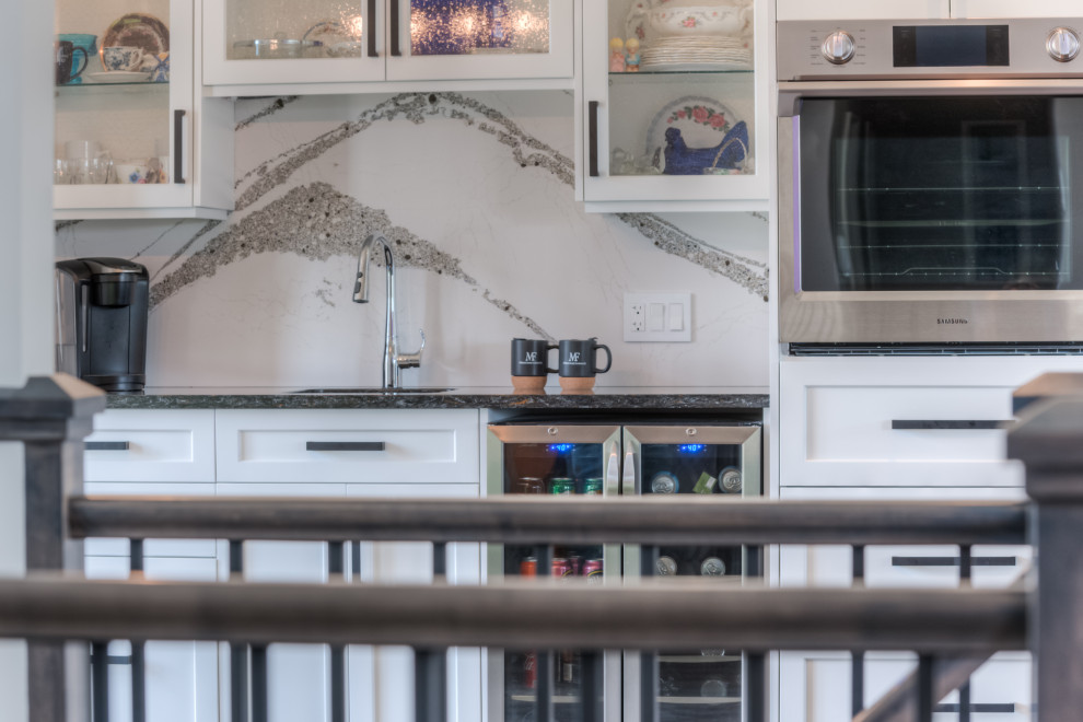 Inspiration for a transitional eat-in kitchen remodel with shaker cabinets, white cabinets, stainless steel appliances and an island