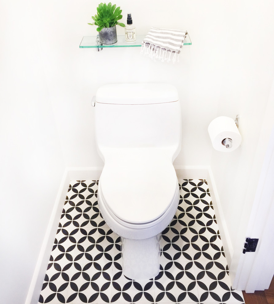 Inspiration for a small transitional powder room in Santa Barbara with open cabinets, medium wood cabinets, a one-piece toilet, black and white tile, cement tile, white walls, a vessel sink and wood benchtops.