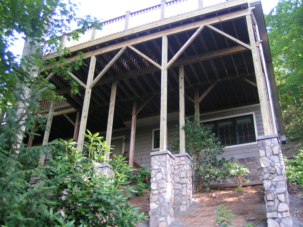 Example of a large arts and crafts backyard deck design with no cover