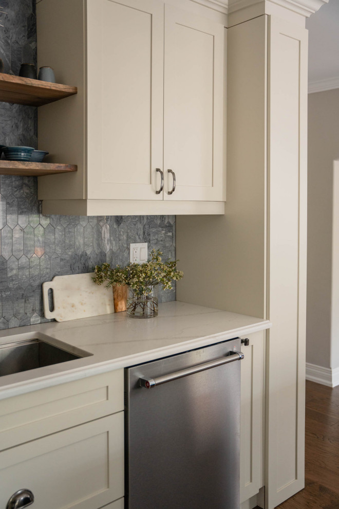 Mid-sized transitional l-shaped dark wood floor and brown floor eat-in kitchen photo in Toronto with an undermount sink, shaker cabinets, white cabinets, quartz countertops, gray backsplash, marble backsplash, stainless steel appliances, an island and multicolored countertops