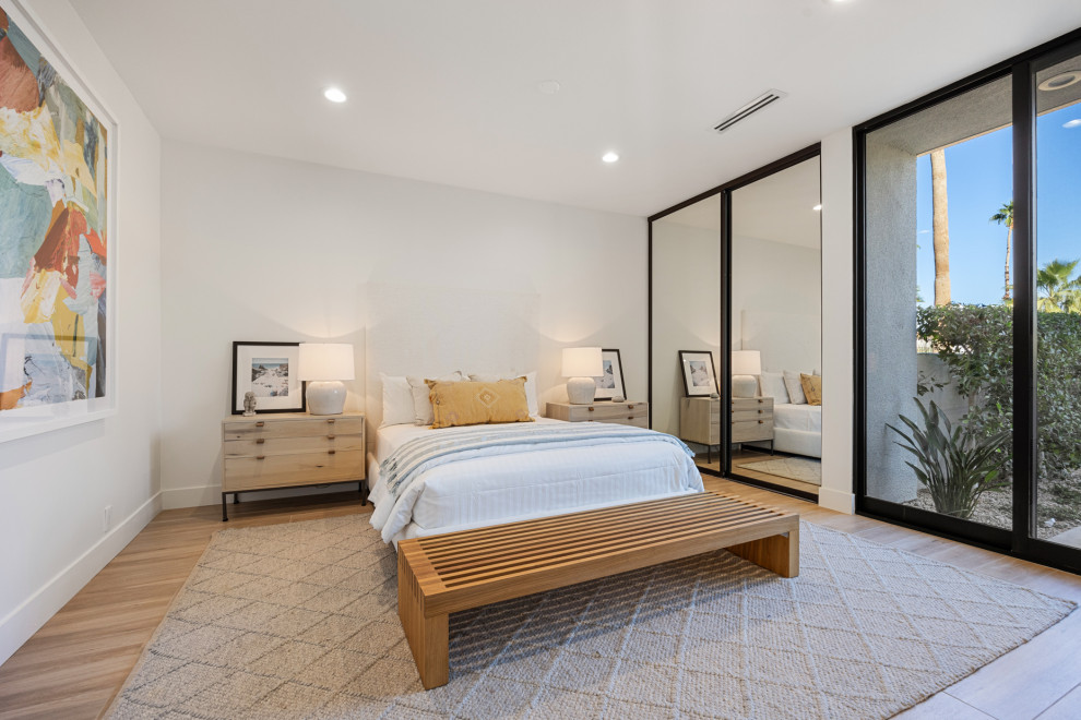 Inspiration for a mid-sized transitional guest porcelain tile and beige floor bedroom remodel with white walls and no fireplace