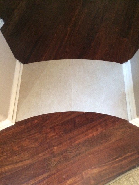 Photo of a small transitional hallway in Orange County with beige walls and medium hardwood floors.