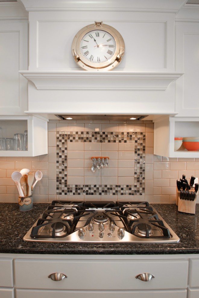 Eat-in kitchen - mid-sized transitional u-shaped dark wood floor eat-in kitchen idea in Milwaukee with a drop-in sink, flat-panel cabinets, stainless steel cabinets, granite countertops, white backsplash, subway tile backsplash, stainless steel appliances and an island