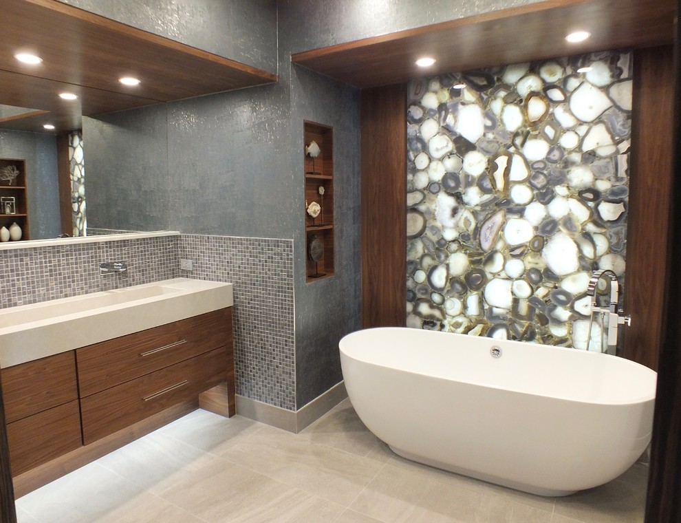 Design ideas for a large contemporary master bathroom in Miami with flat-panel cabinets, brown cabinets, a freestanding tub, a double shower, a one-piece toilet, blue tile, glass tile, ceramic floors, an integrated sink, engineered quartz benchtops, grey floor and beige benchtops.