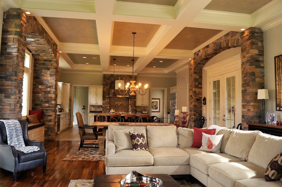 This is an example of a large transitional open concept family room in Columbus with medium hardwood floors, a standard fireplace and a stone fireplace surround.