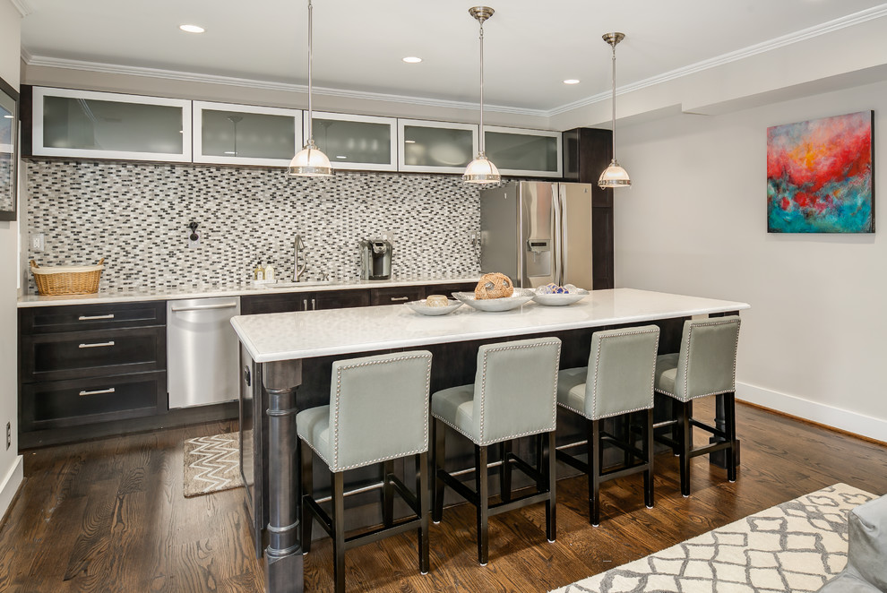 Inspiration for a transitional galley seated home bar in DC Metro with shaker cabinets, dark wood cabinets, multi-coloured splashback, matchstick tile splashback, dark hardwood floors, brown floor and an undermount sink.