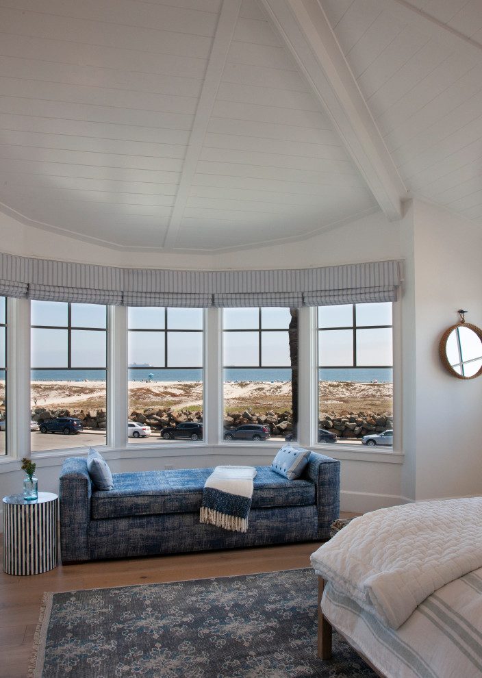 Inspiration for a medium sized nautical guest bedroom in San Diego with white walls, light hardwood flooring, beige floors and a vaulted ceiling.