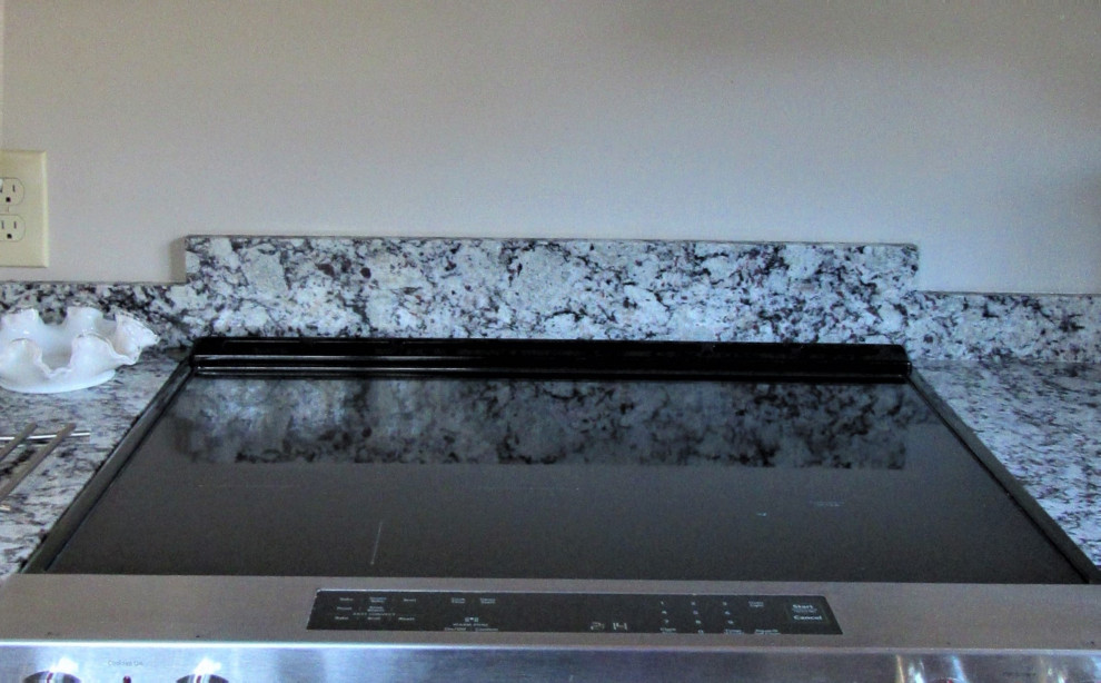 Mid-sized transitional u-shaped eat-in kitchen photo in Boston with an undermount sink, shaker cabinets, beige cabinets, granite countertops, stainless steel appliances, a peninsula and gray countertops