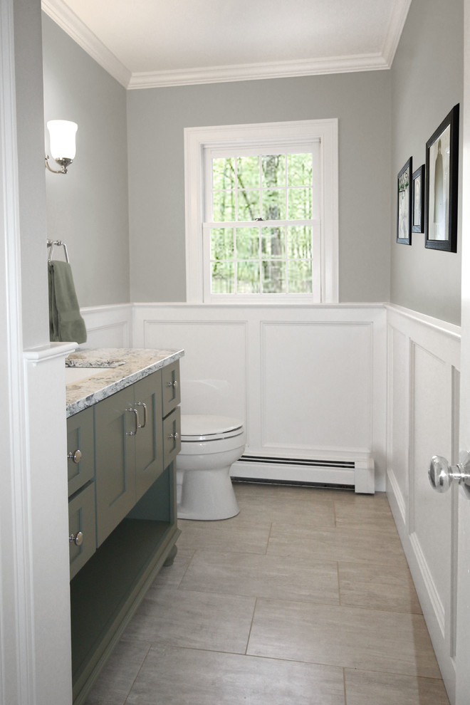 Mid-sized traditional powder room in Boston with shaker cabinets, green cabinets, a two-piece toilet, grey walls, porcelain floors, an undermount sink, engineered quartz benchtops and grey floor.