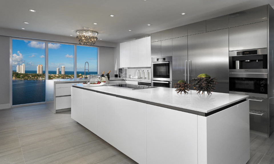 Design ideas for a large modern l-shaped eat-in kitchen in Miami with an undermount sink, flat-panel cabinets, stainless steel cabinets, quartzite benchtops, white splashback, stone slab splashback, stainless steel appliances, porcelain floors and with island.
